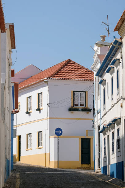 The red facade with three white windows and a balcony door
