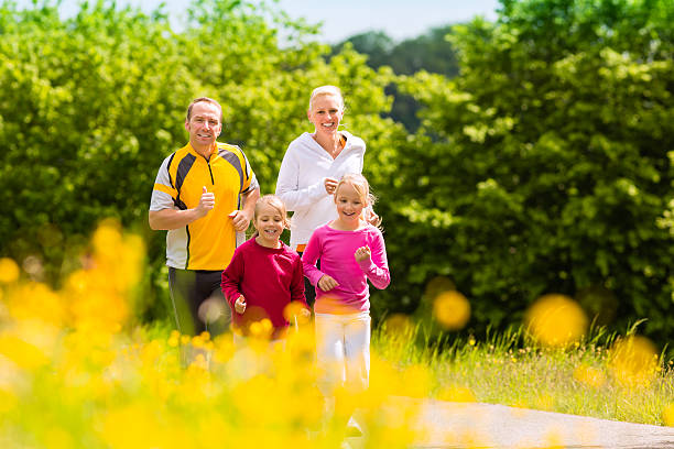 istock A healthy family jogging through a park 149867323