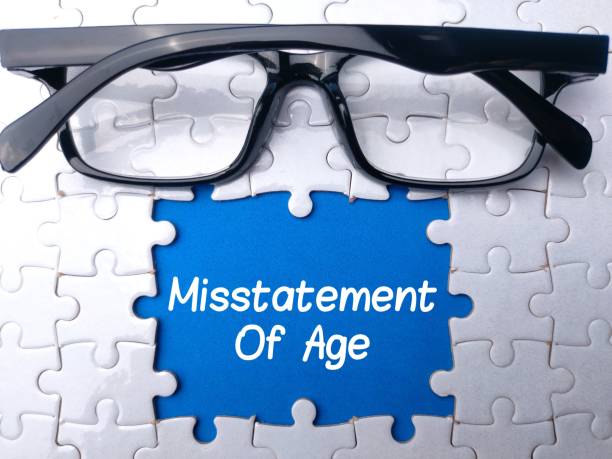 white jigsaw puzzle with glasses and text: misstatement of age. business concept. - misapplication imagens e fotografias de stock