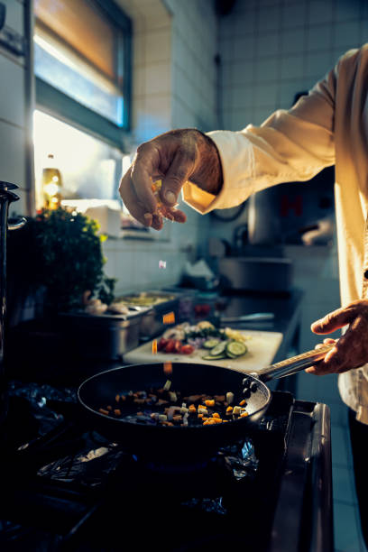 istock Chef cooking in a commercial kitchen. 1498674451