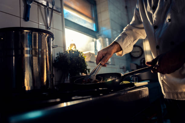 istock Chef cooking in a commercial kitchen. 1498674476