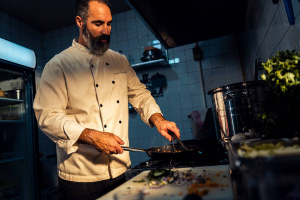 istock Chef cooking in a commercial kitchen. 1498674478