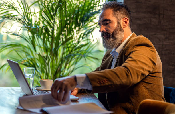 istock Businessman working in cafe using laptop. 1498674497
