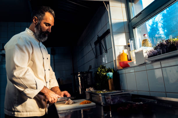 istock Chef cooking in a commercial kitchen. 1498674572
