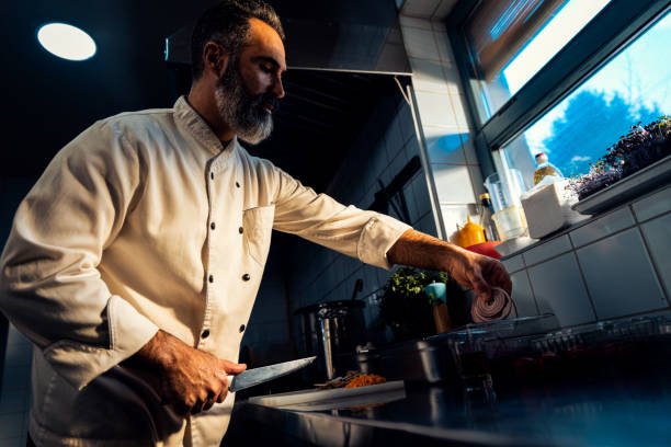 istock Chef cooking in a commercial kitchen. 1498674581