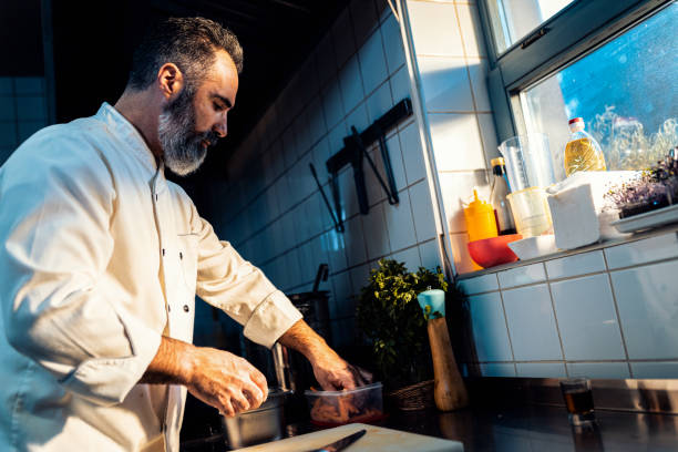 istock Chef cooking in a commercial kitchen. 1498674590