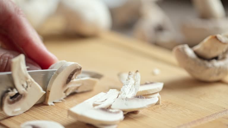 Cutting raw mushrooms for cooking