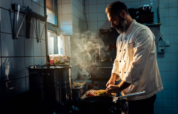 istock Chef cooking in a commercial kitchen. 1498674651