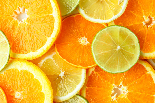 istock fresh orange fruits with leaves as background, top view.Orange fruit pattern. 1498682030