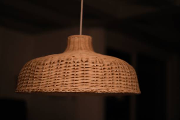 istock Rustic wicker ceiling light hanging from a rope cord, providing a cozy, intimate atmosphere 1498682046
