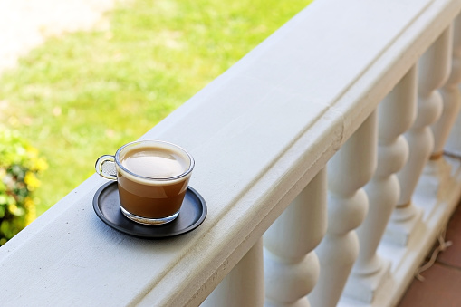 A glass of latte in a garden