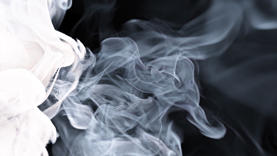 Rising and falling  smoke stream on a black background. The background can be remove with a blending mode like screen.