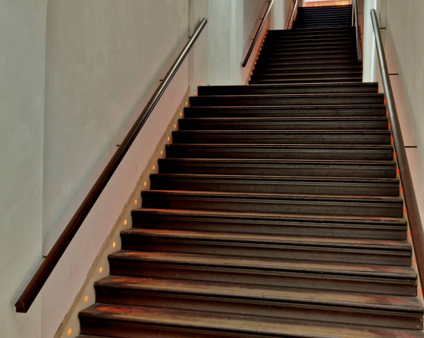 istock covered staircase with step lighting from the side. spotlights in the wall. wooden paneling leads down the hill through a covered portico tunnel 1498687889