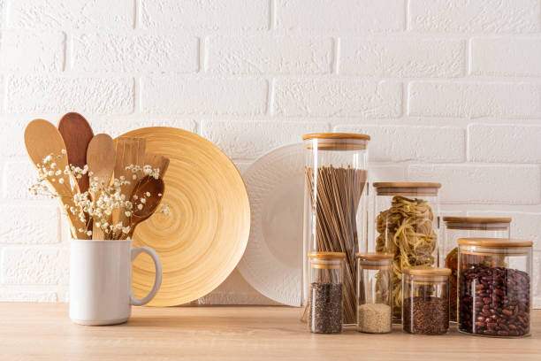 istock Compact, stylish storage of bulk products in glass jars with bamboo lids. front view. White brick wall. kitchen background. 1498688588