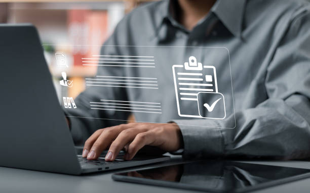 istock Businessman checkmarking for approval document, online paperless approval and quality assurance concept. 1498694493