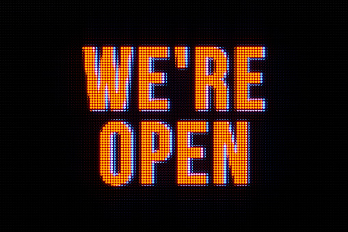 The text, we're open, in orange. Small business, open sign, announcement message, commercial sign, beginnings, event, retail place, store and information sign.