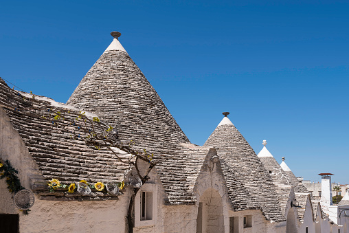 Scenic view of trulli whitewashed huts with conical roofs in Alberobello in Apulia in Italy