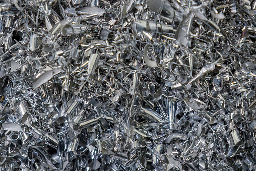 Close-up scene of  aluminum  materials scrap from turning process. The pile of lathe chips.