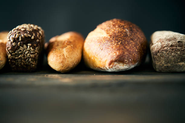 Different types of bread loaves close up with copy space. Bakery, food concept background