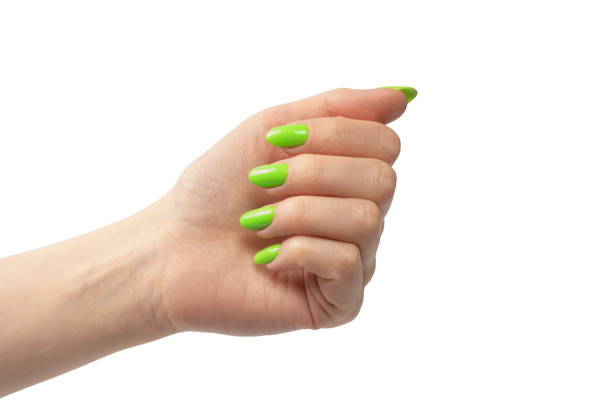 istock Hand of a woman with green naols hold some tiny or thin object. 1498703402