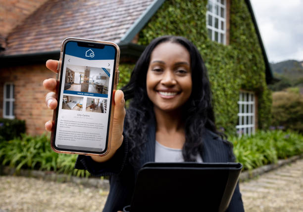 istock Happy real estate agent using a mobile app to list properties 1498704680