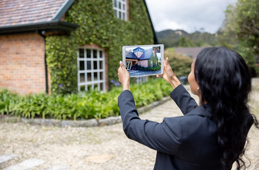 African American real estate agent making a virtual tour of a house via using a tablet computer