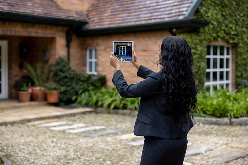 African American real estate agent making a virtual tour of a house via video chat using a tablet computer