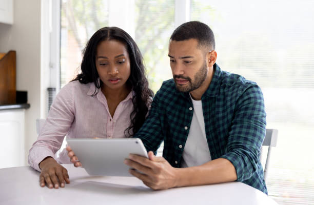 istock Worried couple getting bad news while talking on a video call 1498704767