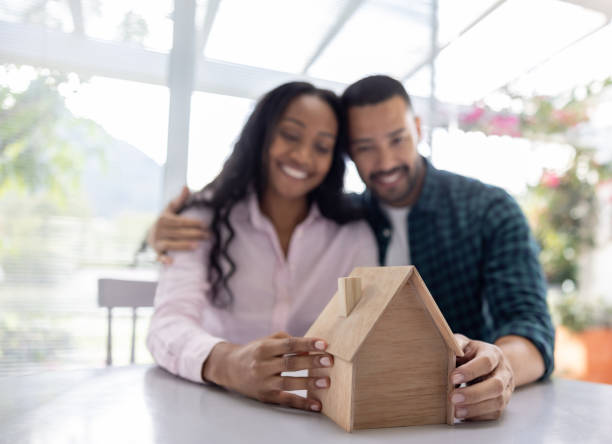 istock Happy couple looking at a house model 1498704779