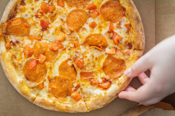 istock Pizza Pepperoni in a carton box. view from above 1498704963