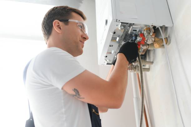 professional boiler service: qualified technician checking a natural gas boiler at home - huisverwarming fotos stockfoto's en -beelden