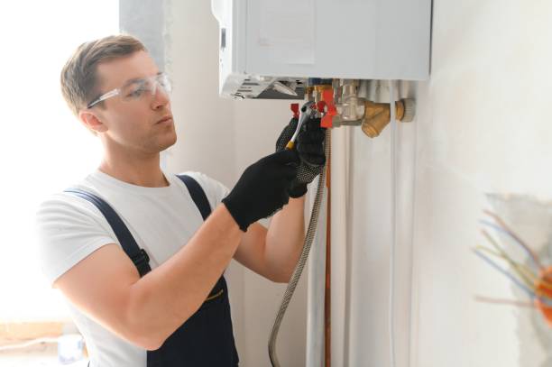 istock Professional plumber checking a boiler and pipes, boiler service concept 1498705088