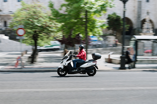 Santander, Spain - 14 June 2023: A motor scooter in motion in Santander, Spain