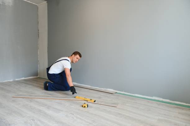 istock Man installing new laminated wooden floor 1498706397