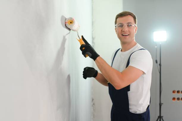 istock One painter with paint roller making wall prime coating at home repair renovation work. 1498706861