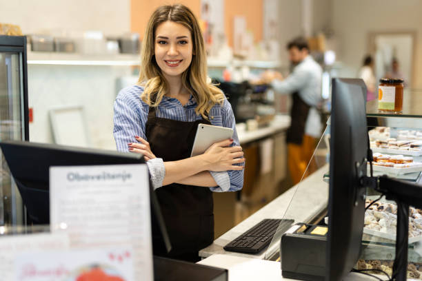 istock Smiling young baker at the checkout counter. 1498712190