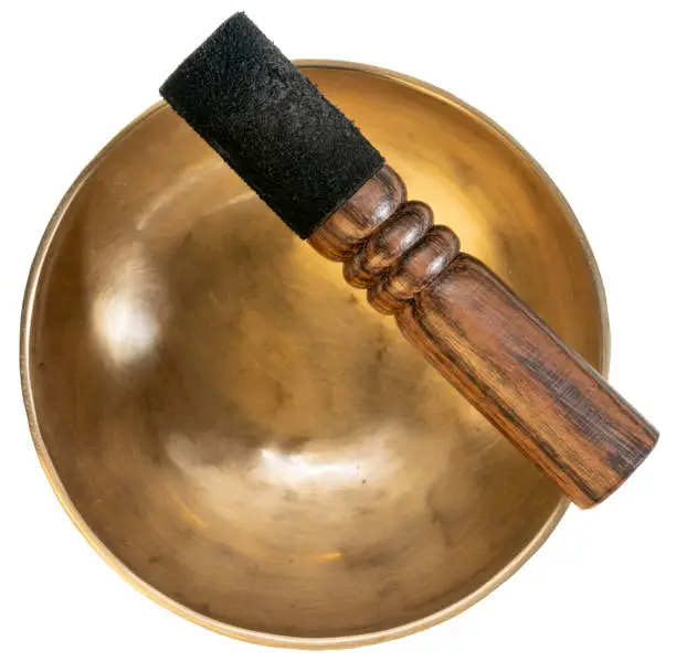 handmade tibetan singing bowl with a mallet isolated on white, sound therapy for healing, relaxation and meditation