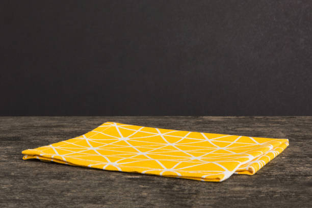 istock top view with yellow empty kitchen napkin isolated on table background. Folded cloth for mockup with copy space, Flat lay. Minimal style 1498713887