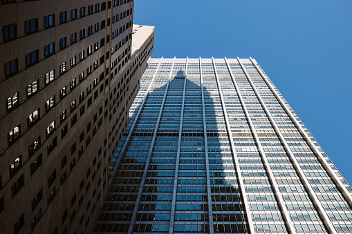 View on isolated glass facade of skyscraper with countless windows and reflection of clouds and sky - Düsseldorf, Germany