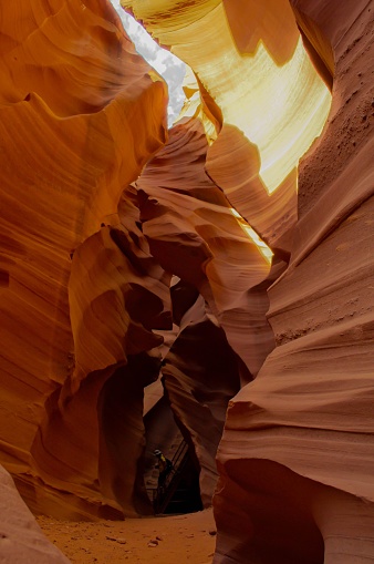 A vertical photograph of a stunning, awe-inspiring landscape in the form of Antelope Canyon