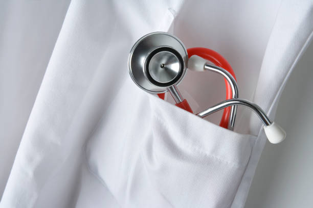 istock Stethoscope in white doctors coat close up 1498718128