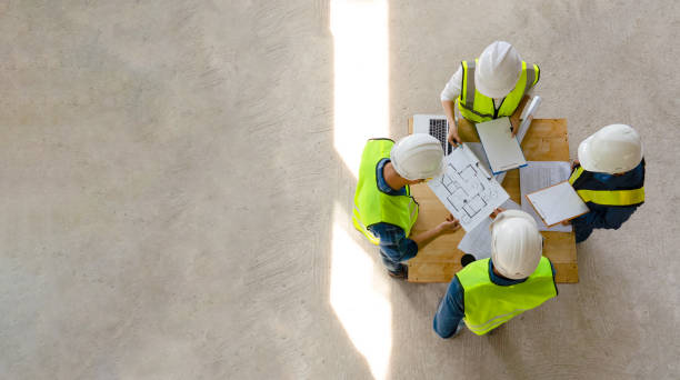 istock top view engineer discuss meeting together with architect foreman team while inspecting material of infrastructure construction progress for sustainable green building at site preparation copy space 1498718776