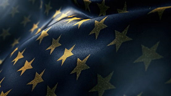 Shiny golden stars on dark blue waving flag holiday background