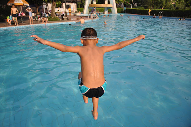 istock The boy jumps into  swimming pool 149872081