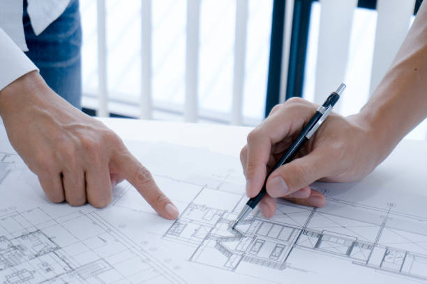 istock Colleagues interior designer Corporate Achievement Planning Design on blueprint Teamwork Concept with compasse. 1498720829