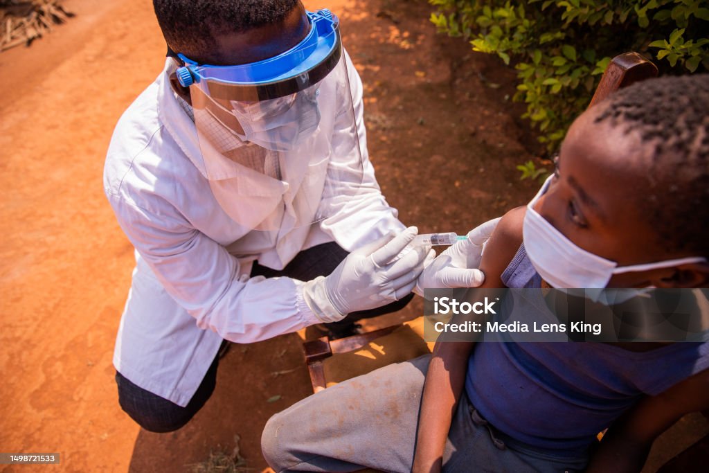 A doctor vaccinates a child in Africa during a medical visit Malaria Stock Photo A doctor vaccinates a child in Africa during a medical visit Malaria Stock Photo