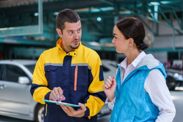 istock Vehicle technician talking with female customer. 1498723605