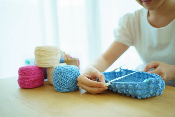 istock Woman making a handcraft crochet bag. 1498723778