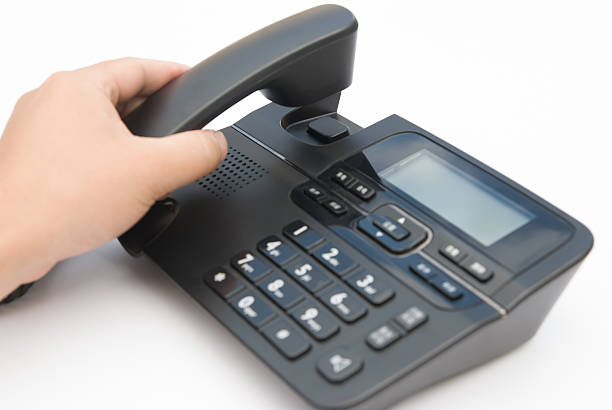 istock man lifting up a telephone receiver 149872450