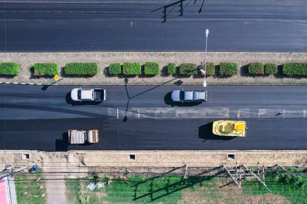 istock New asphalt road and road roller working in improvement project 1498725717